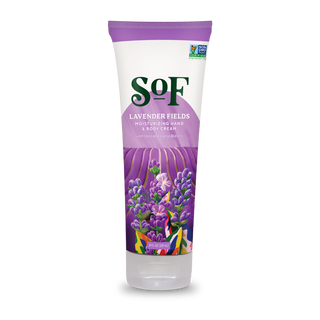 A tube of Lavender Fields Hand and Body Cream with a purple cap, lavender flower illustrations, and front product text, enriched with Fair Trade shea butter for gentle, nourishing care.